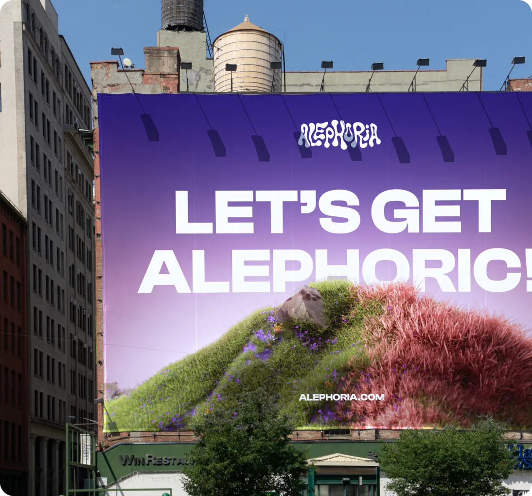 Large billboard on a building with purple background and text 'LET'S GET ALEPHORIC!' above a hill with green and pink grass.