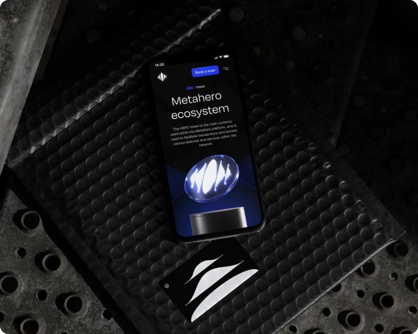 Smartphone displaying the Metahero ecosystem page with a glowing orb graphic and a card with a white abstract logo on a dark textured surface.