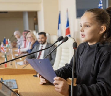 Girl giving speech present on stage with microphone