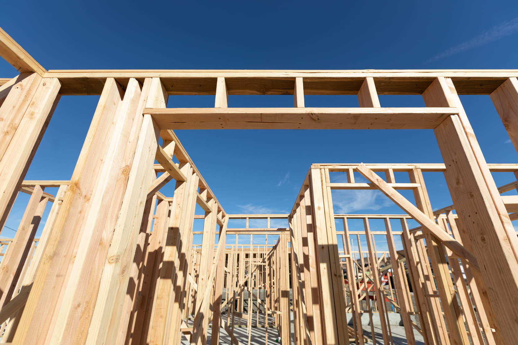 Wooden building frame construction showing structural foundation being built, representing marketing operations infrastructure for dental clinics