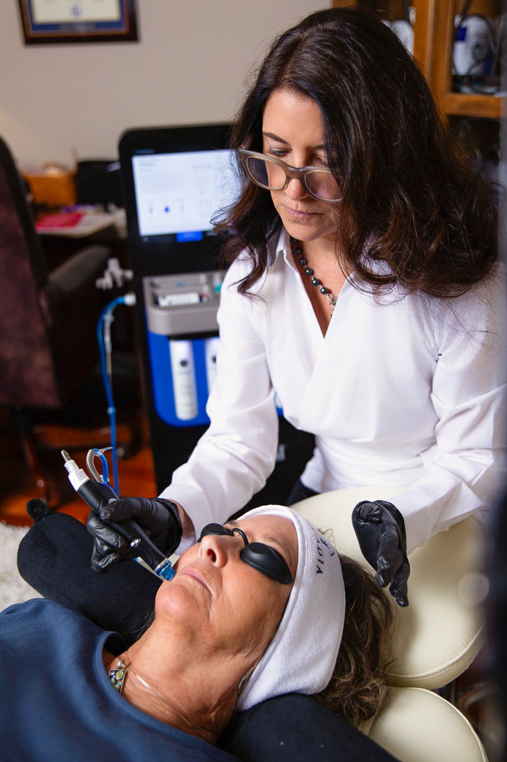 Dr. Samantha Wesner Performing HydraFacial on a patient