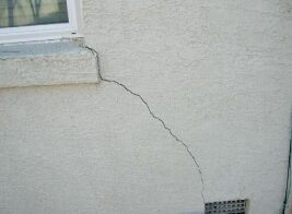 A large crack where stucco is failing. 