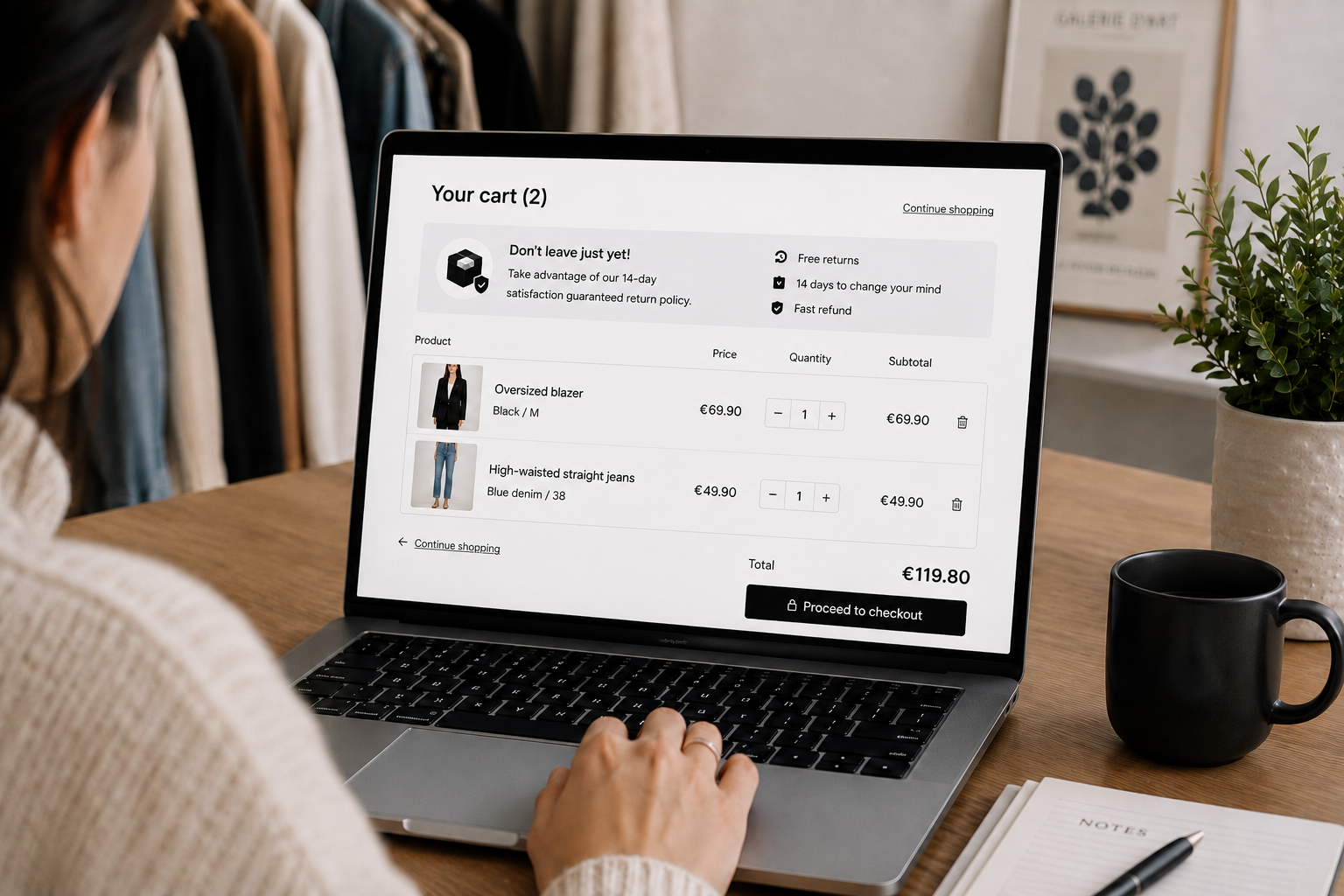 Woman viewing an online fashion cart with a clear return policy on a laptop.