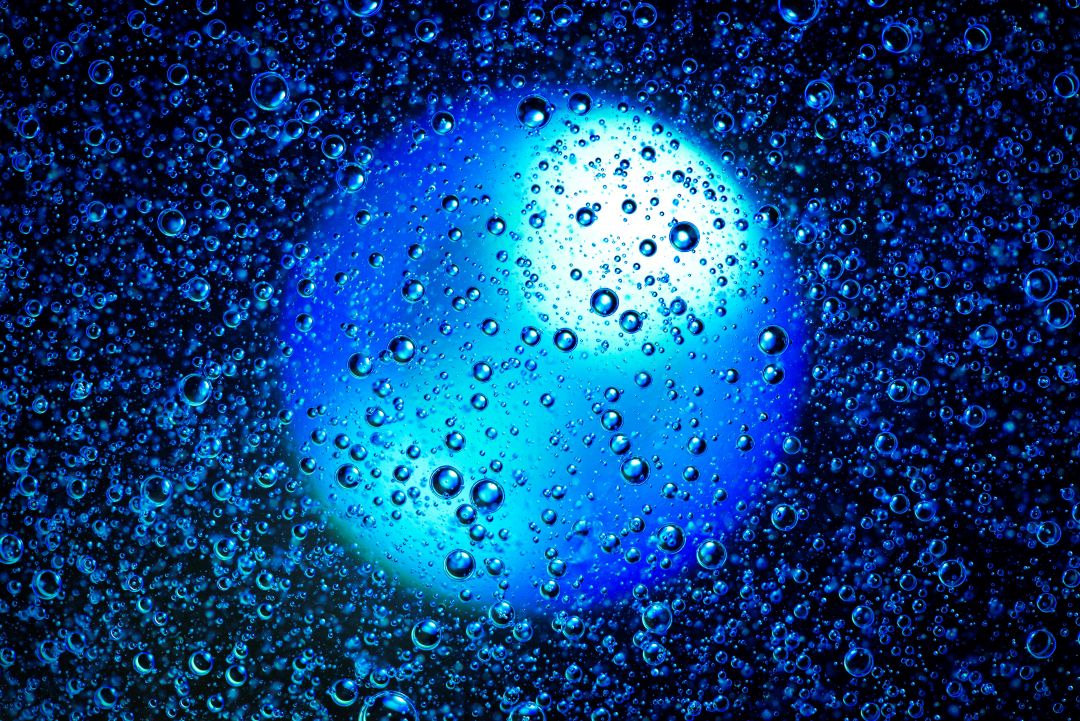 Blue gas bubbles against a glowing background.
