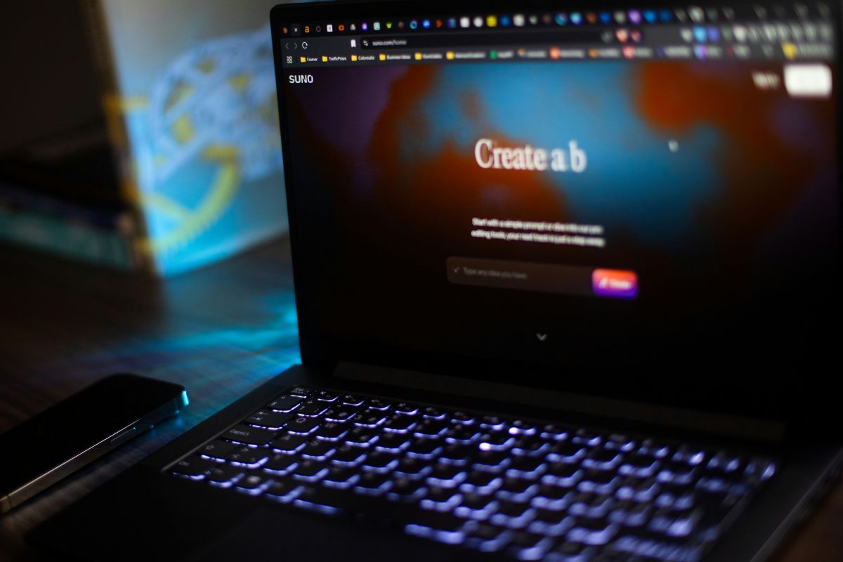 Laptop displaying a creative web application in a dark setting.