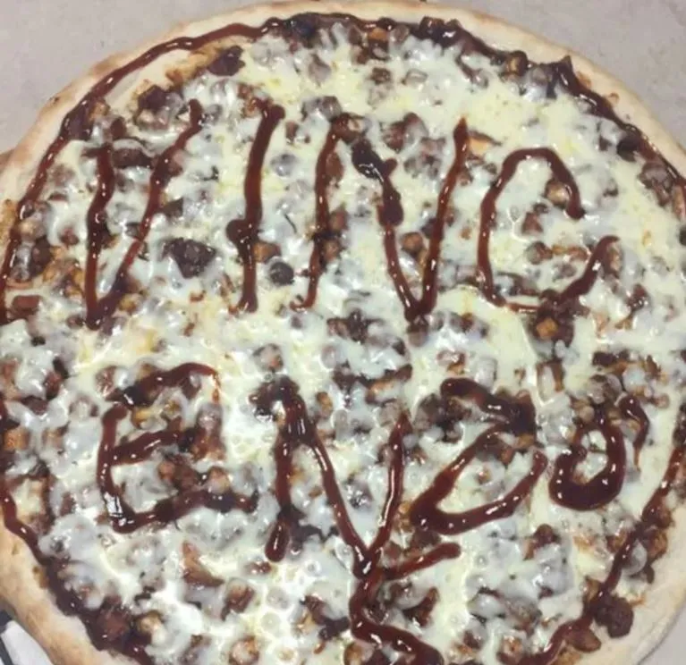 A pizza with the word vinging written on it.