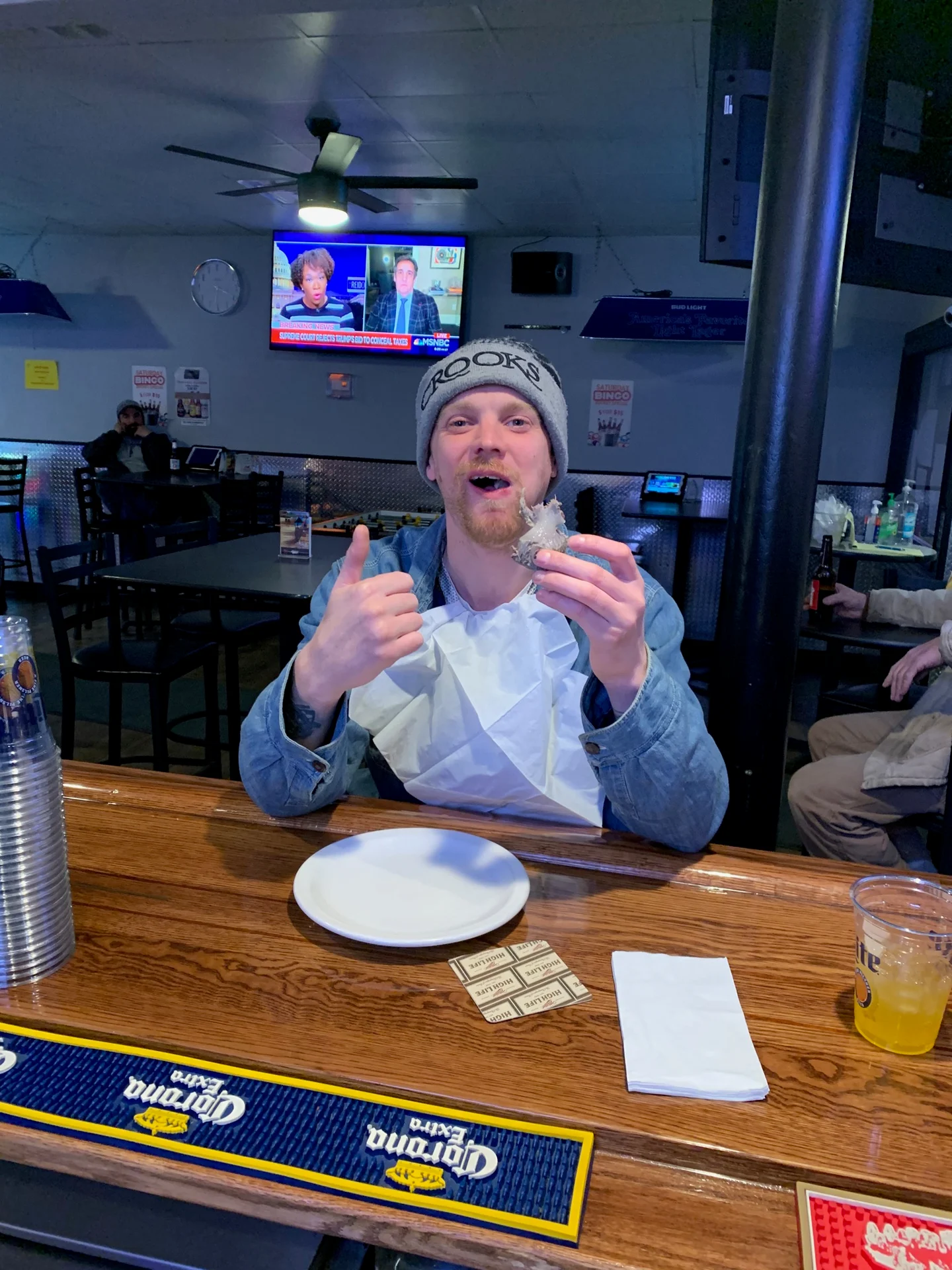 A customer posing in front of the camera inside Cedar Inn