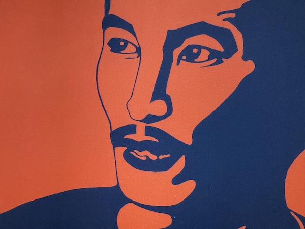 Stylized image in dark orange and navy blue of an Asian man with a mustache in three-quarters side profile. From a closeup of the cover of the book Freedom without Justice: The Prison Memoirs of Chol Soo Lee.