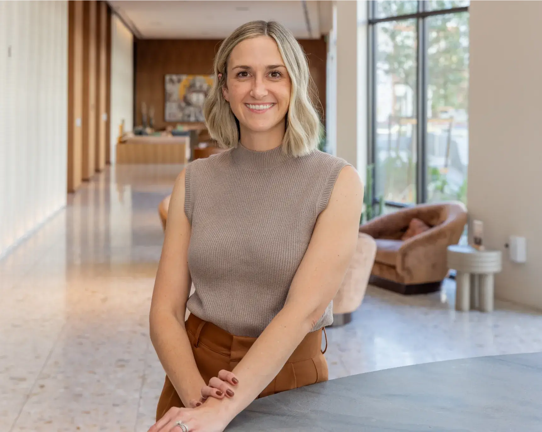 Dr. Toni Torres standing on a counter in a lobby.
