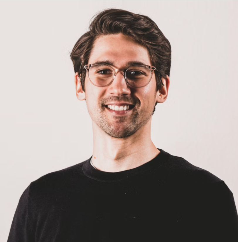 Customer testimonial photo of a man with glasses smiling