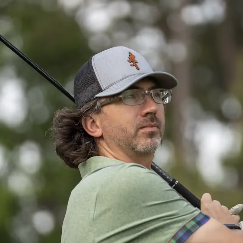 Focused golfer watching his ball after his shot