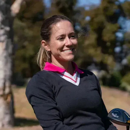 Woman smiling outside on the golf course
