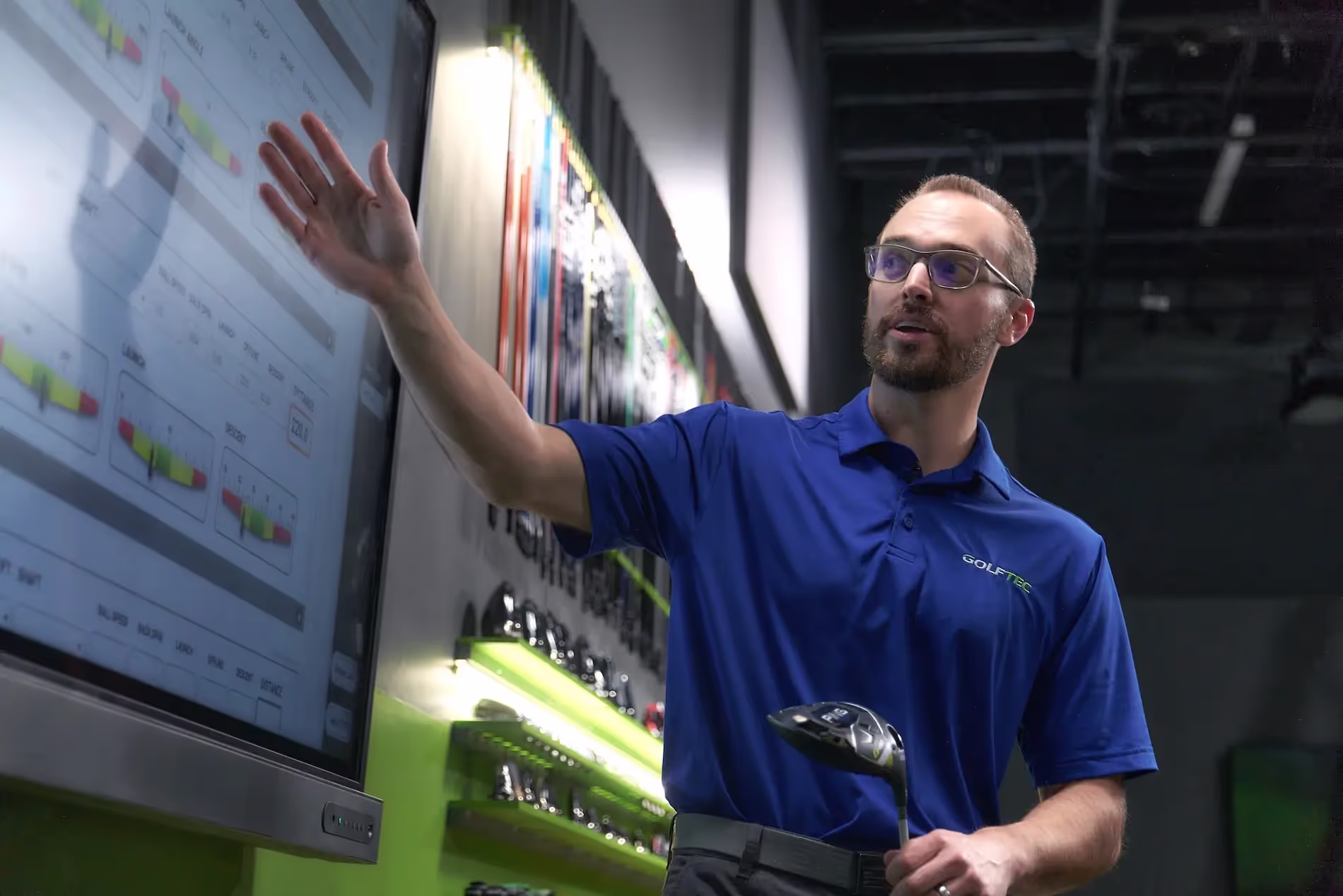 Coach breaking down data for student during a club fitting