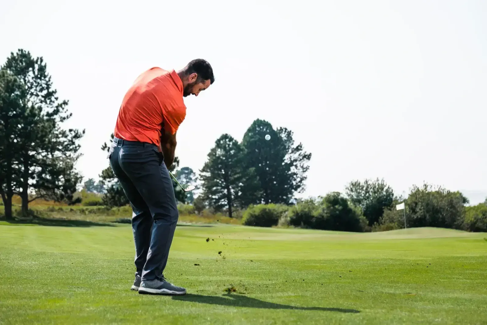 Man chipping the ball onto the green