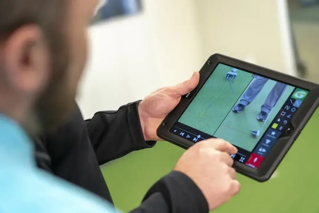 GOLFTEC coach reviewing putt with student on iPad 