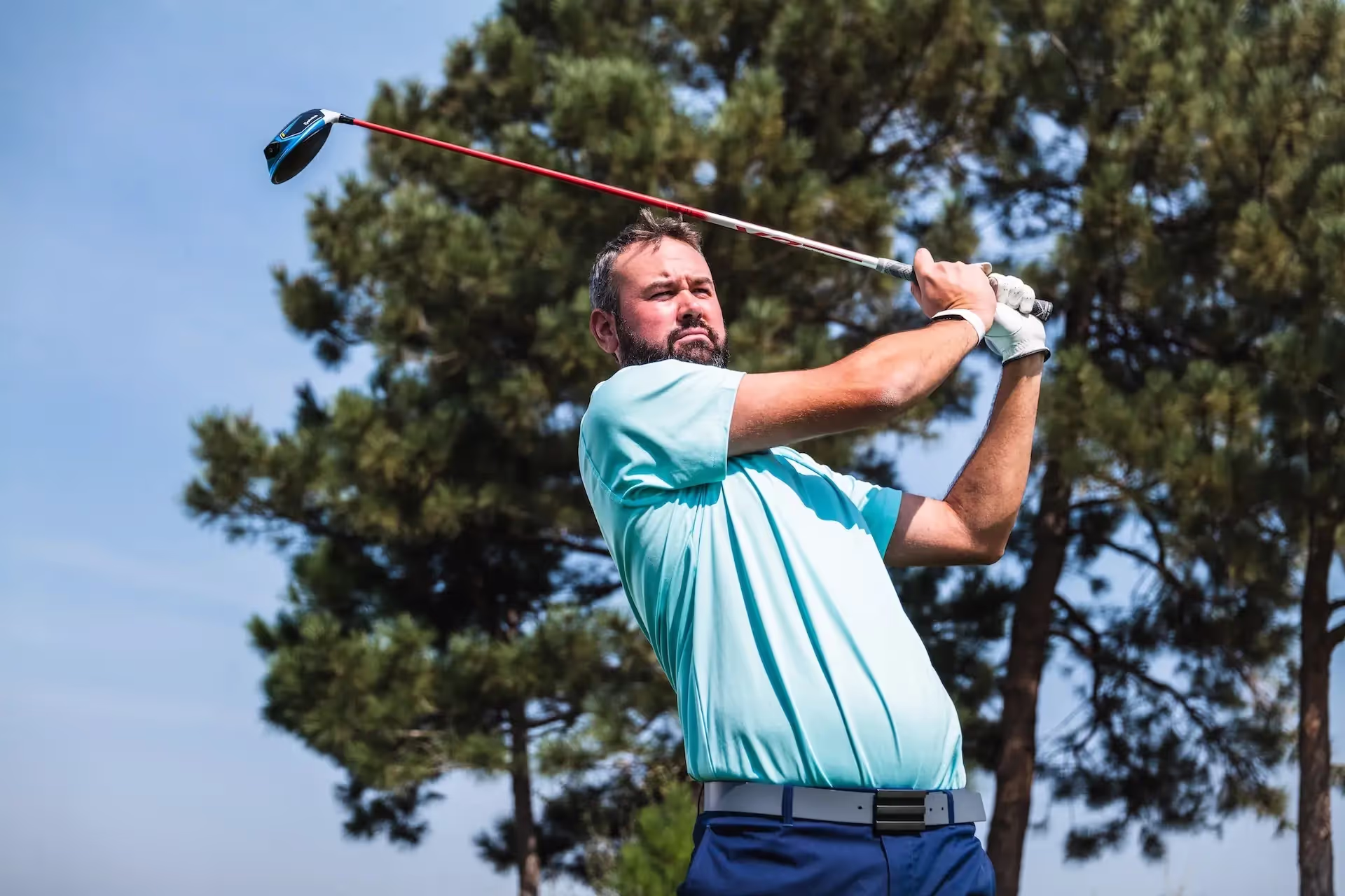 Man watching his ball after his shot from the tee box