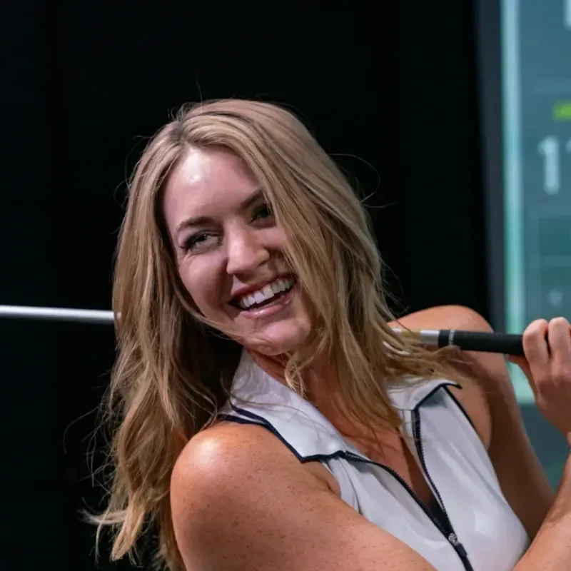 Smiling after a swing during a GOLFTEC lesson