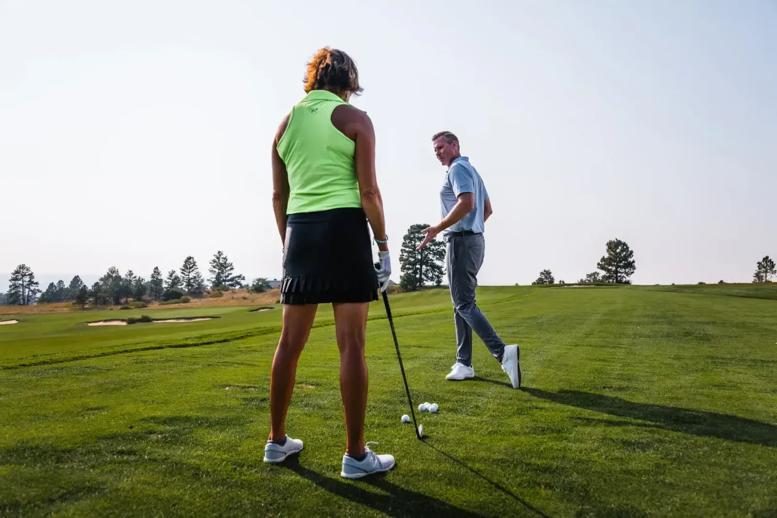 Student and coach working on swing at the range
