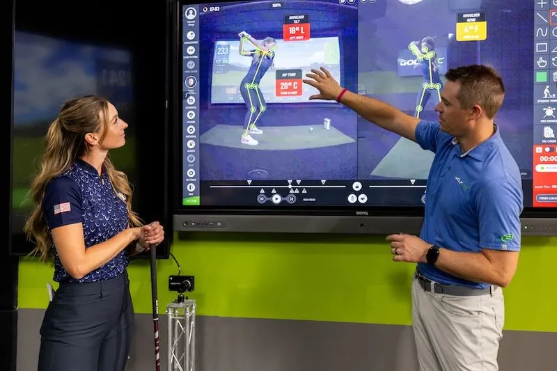 GOLFTEC coach using OptiMotion for swing breakdown with female golfer