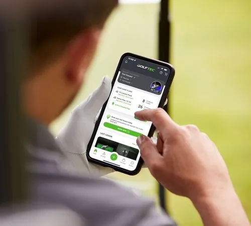 Booking a GOLFTEC golf lesson on a smartphone screen