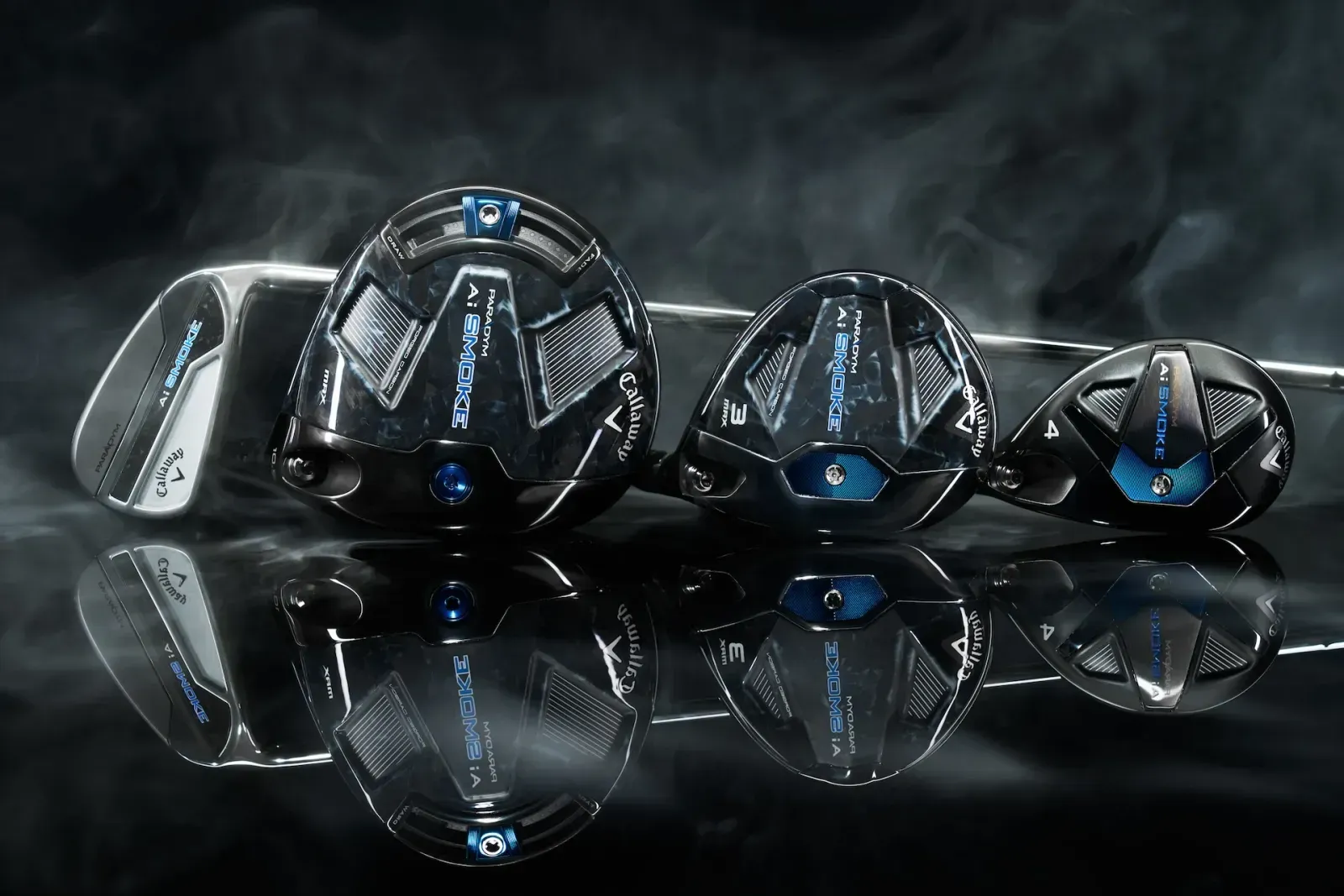Callaway driver, fairway wood, hybrid, and iron laying next to each other. 