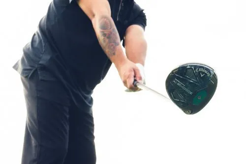 Zoomed-in view of a golfer hovering a Callaway Paradym Ai Smoke Max D Driver over the ball.