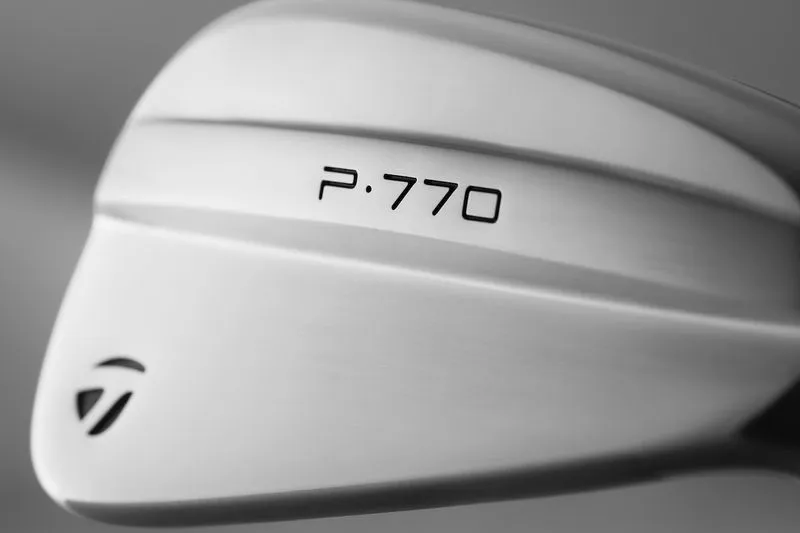 Close-up of the TaylorMade P770 Iron with a grey background.