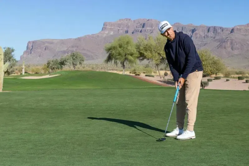 Golfer on the green putting with a PING Scottsdale Putter.