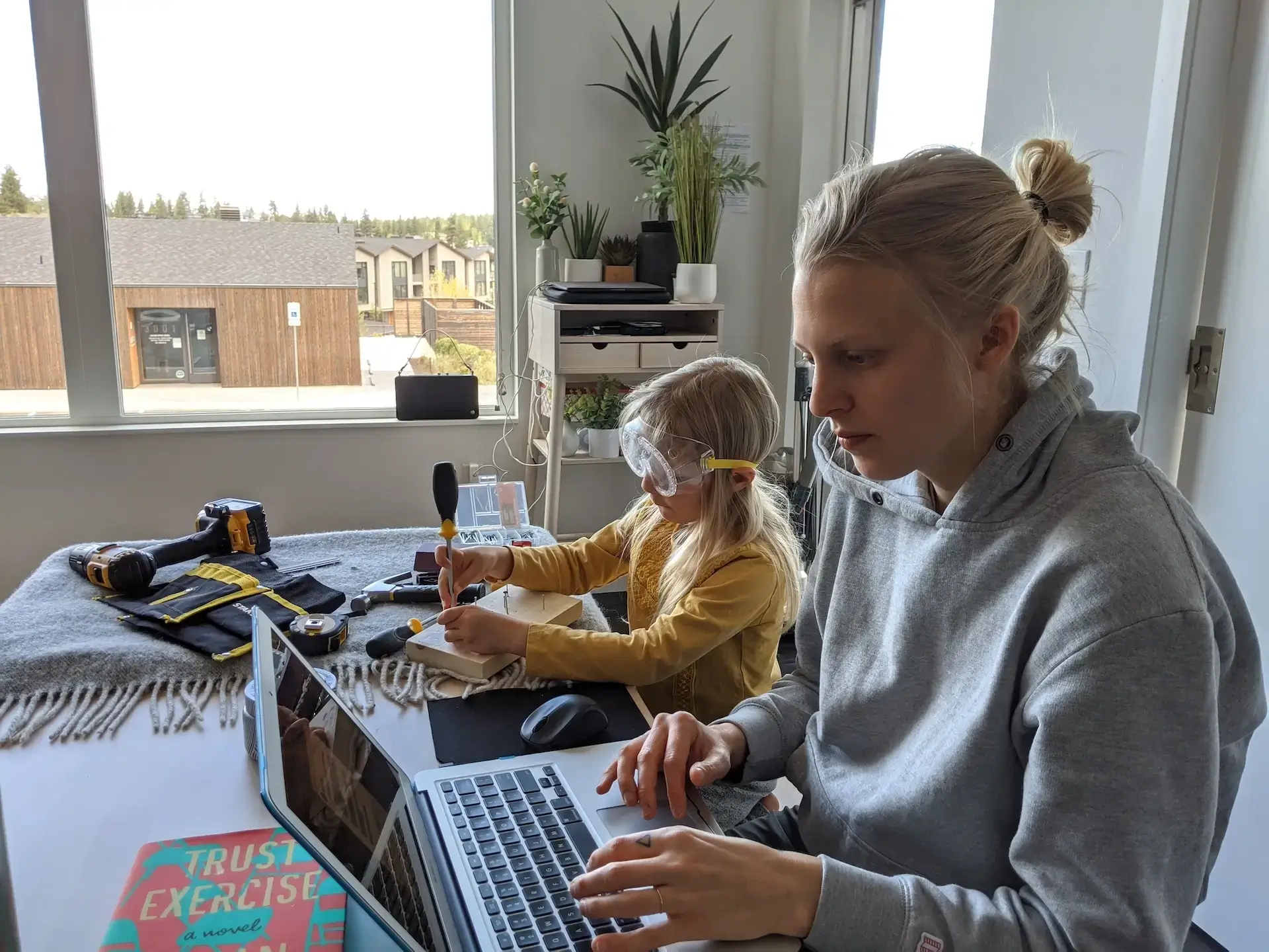 Mom and Daughter working and homeschooling together at the kitchen table. 