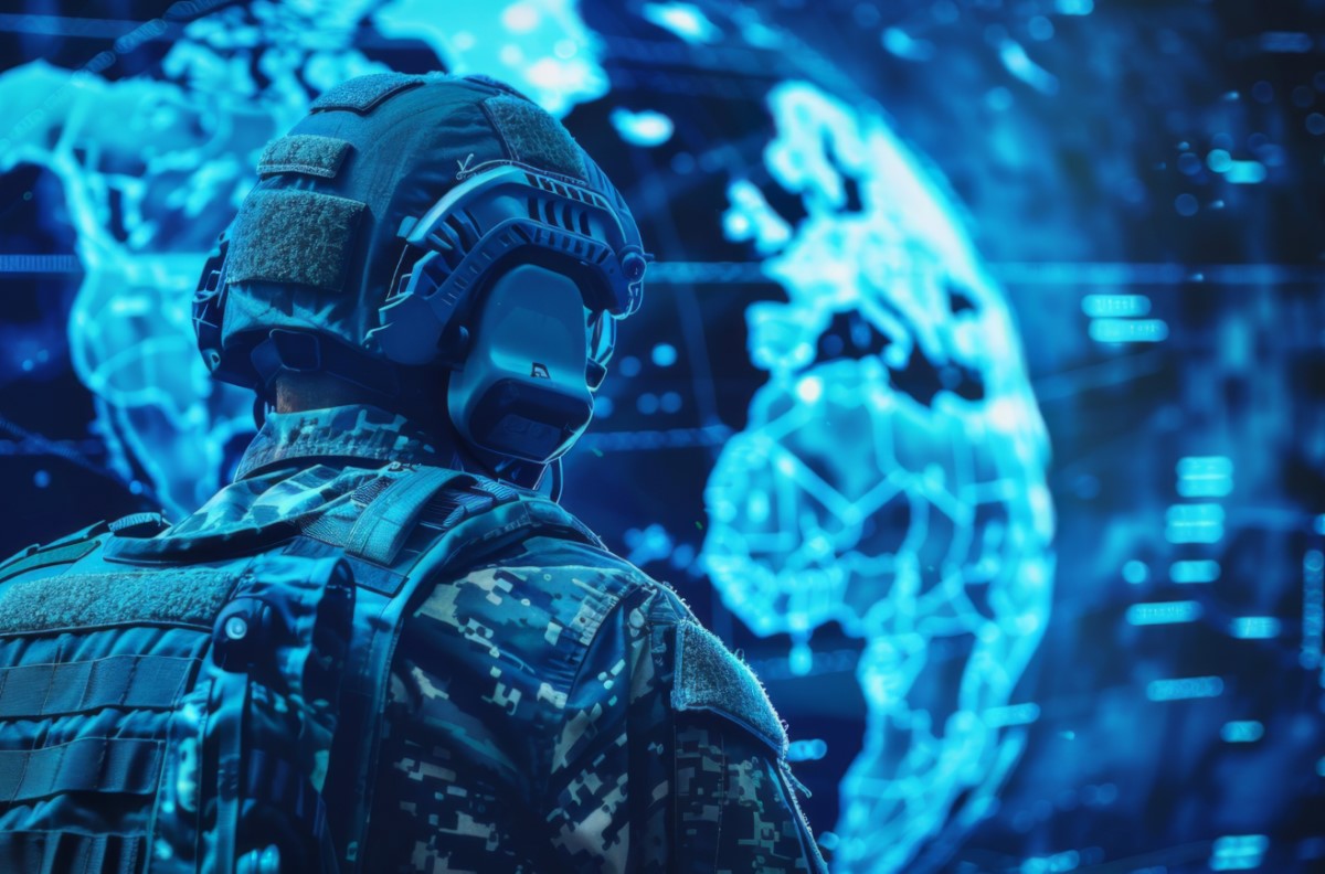 Soldier in tactical gear views digital holographic globe in blue cybernetic environment