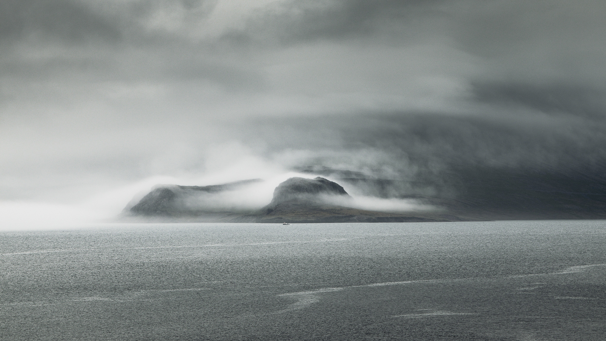 A foggy mountain coastline.