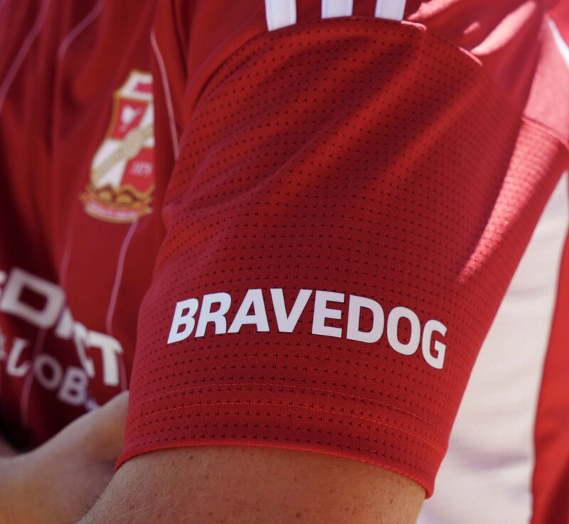 Bravedog logo on the sleeve of the current Swindon Town home shirt