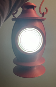 Red, 3D-printed Lantern with light on, viewed from the front
