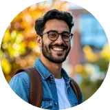 TeachFront testimonial headshot of Asif, smiling outdoors with a backpack and autumn colors in the background