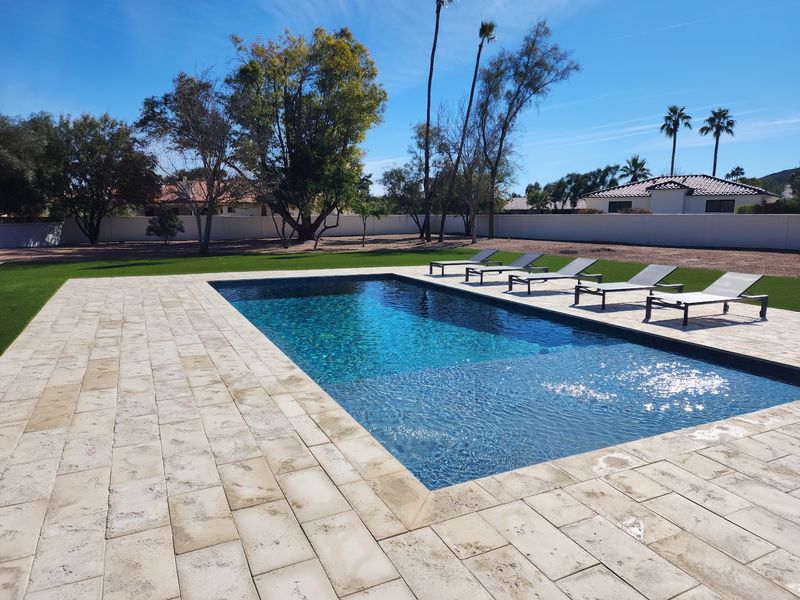 Full resort-style backyard in Scottsdale Arizona with pool, kitchen, and shade structure by ICP
