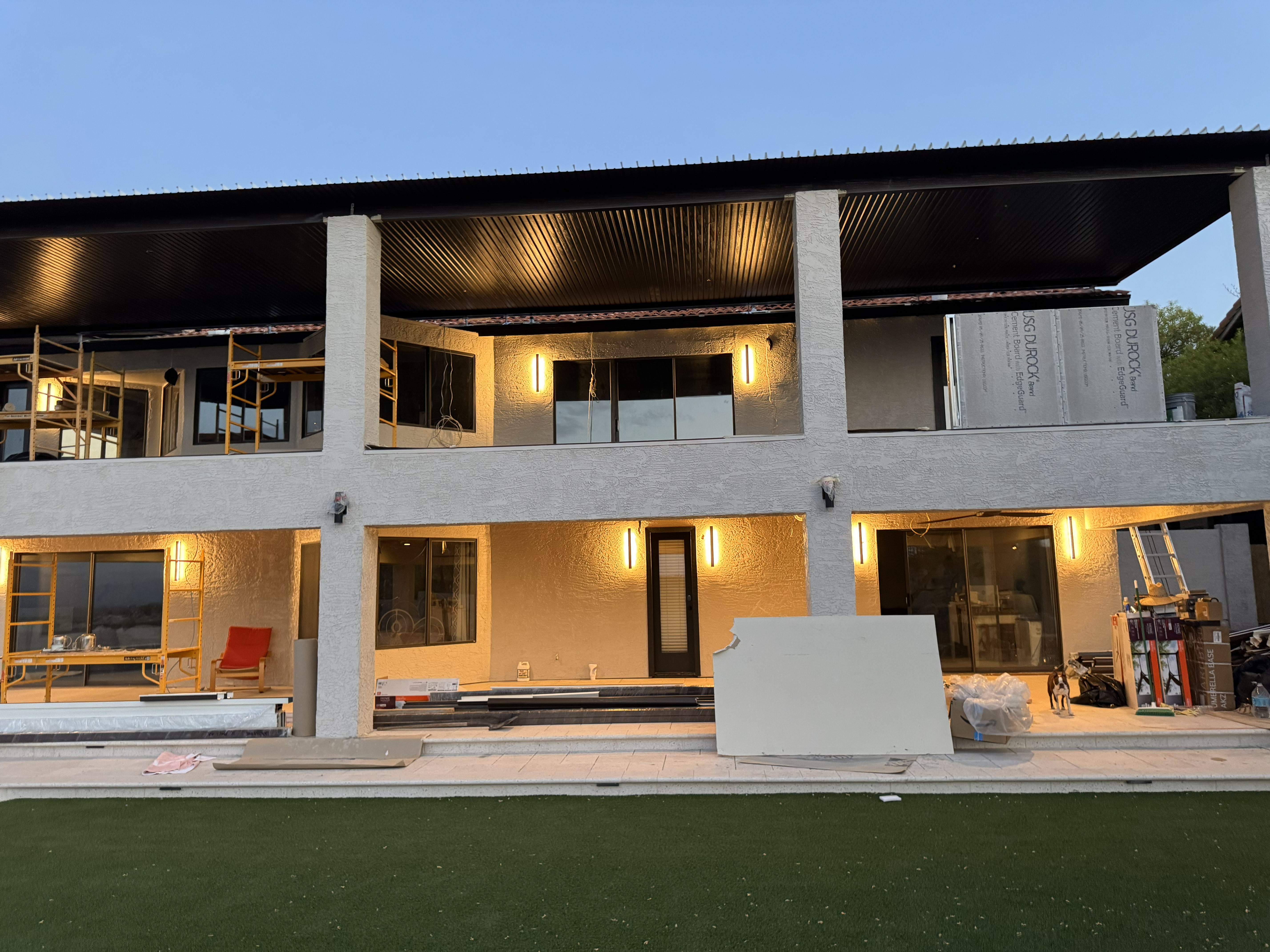 Architectural reconstruction of a Fountain Hills estate featuring structural demolition of original upper and lower patios, installation of new engineered support columns, and integrated modern lighting for a total multi-level outdoor environment overhaul.