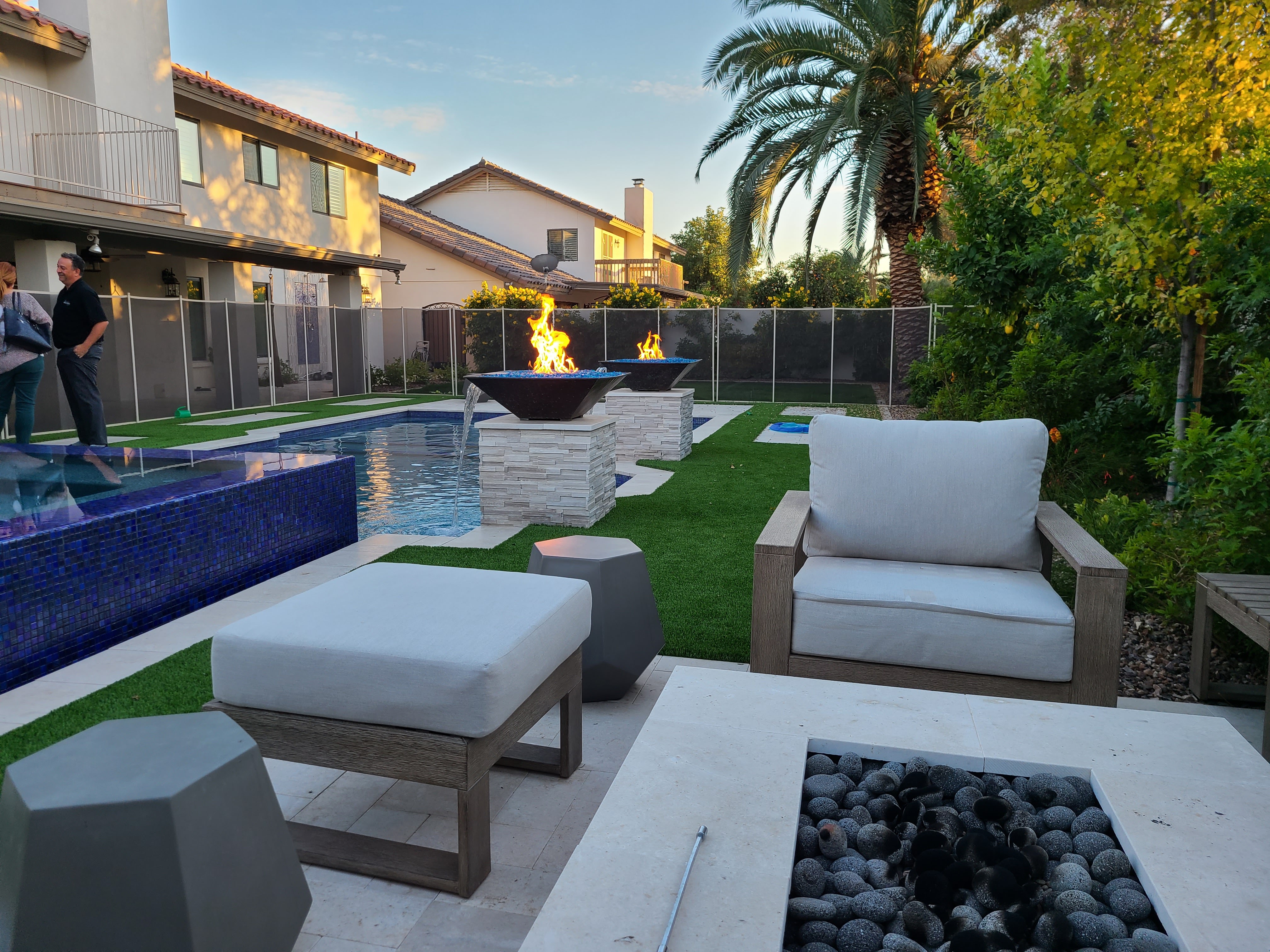 Luxury McCormick Ranch pool remodel featuring a glass-tiled infinity spa, electronic water features, and automated fire elements on custom copper bowls.