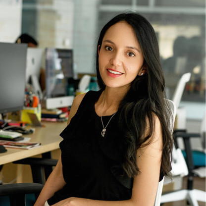 Diana Triana, Senior Product Designer, seated at a modern workspace
