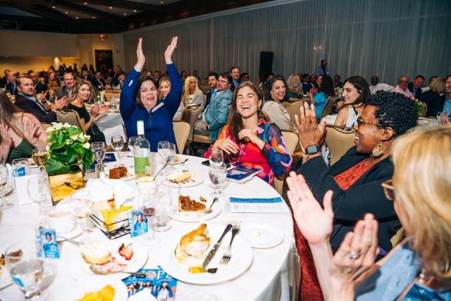 Guests at the 2025 Rey of Hope Gala celebrate a winning bid during the live auction