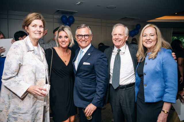 Five guests pose together during the cocktail hour of the 2025 Rey of Hope Gala