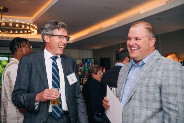A Holy Family Cristo Rey Catholic High School board member chats with another guest at the 2025 Rey of Hope Gala.