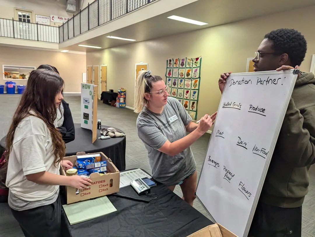 Students from Holy Family Cristo Rey work packing food boxes at Grace Klein Community