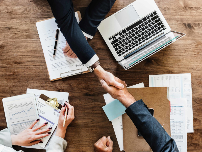 A meeting with 2 people shaking hands