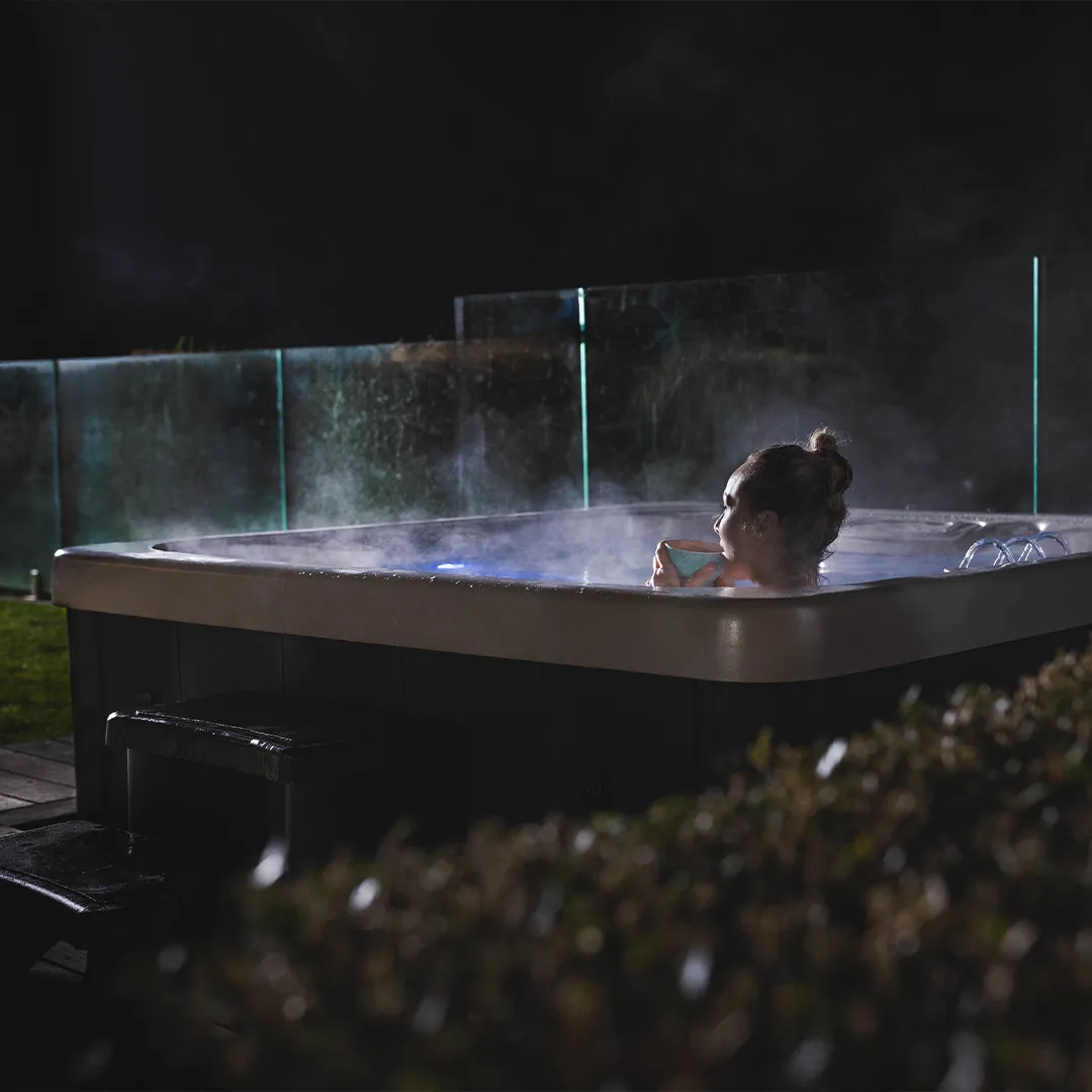 Woman inside Halo spa at night holding a cup