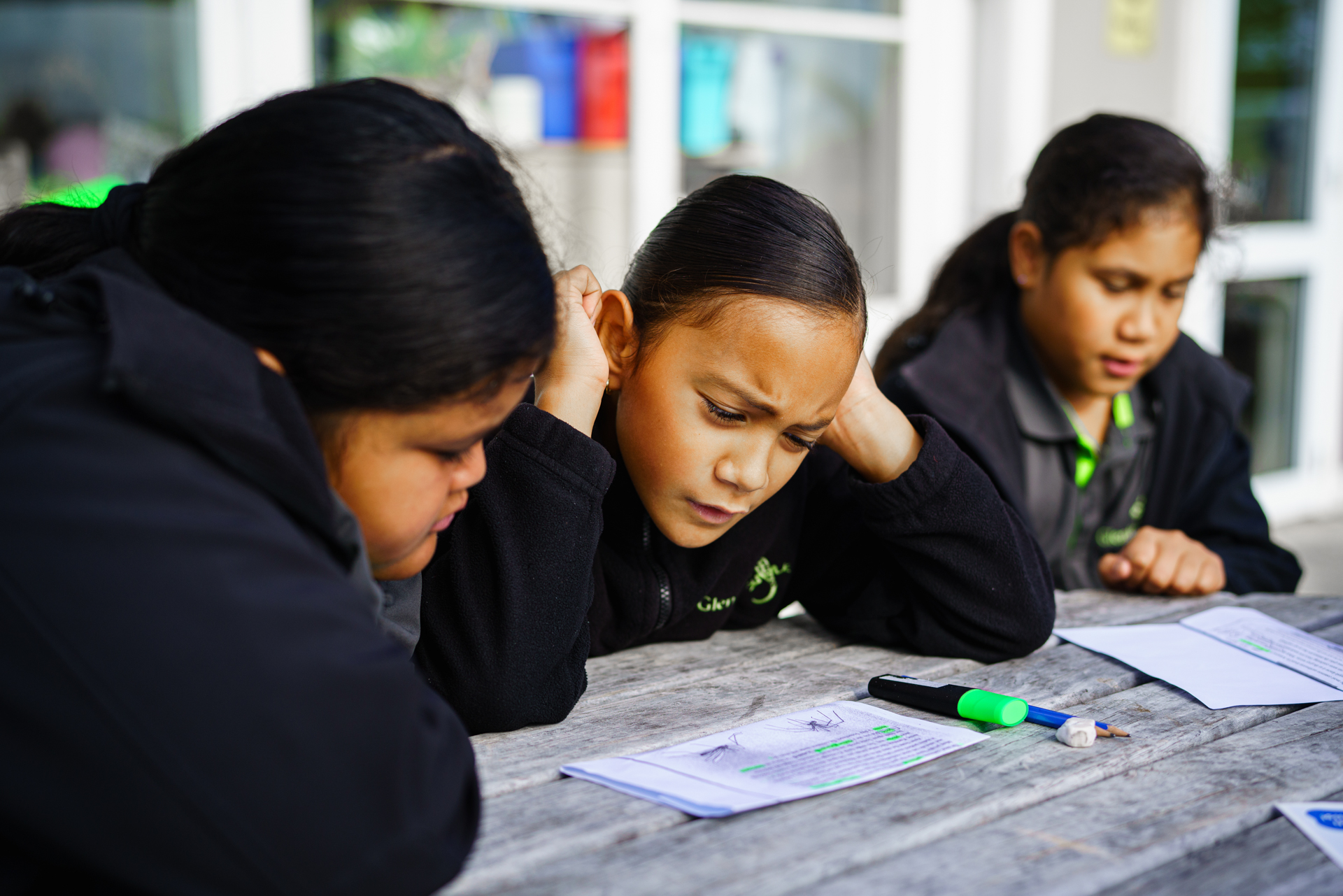 Young students work outside together.