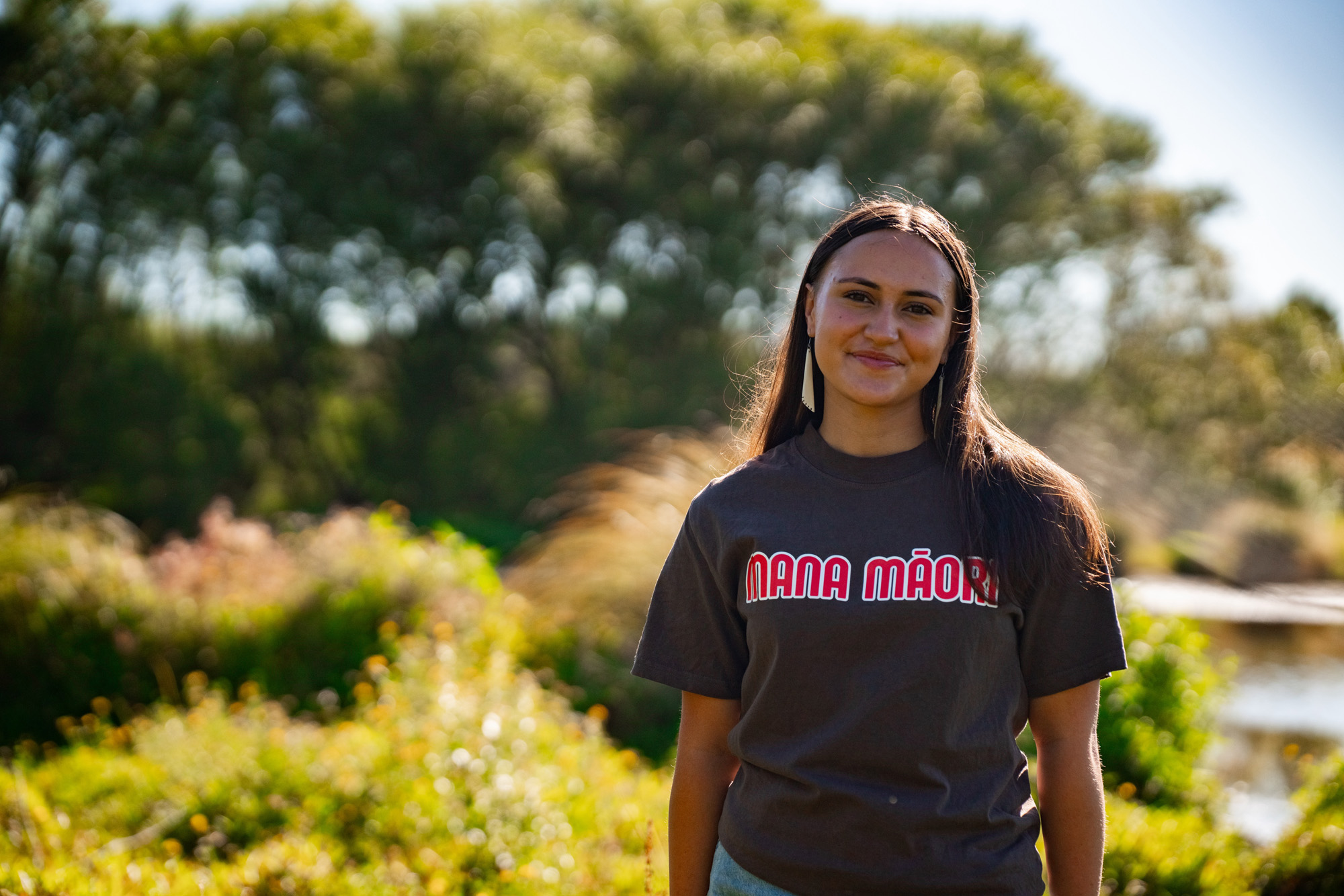 Young woman wearing a t-shirt that reads 'Mana Māori'