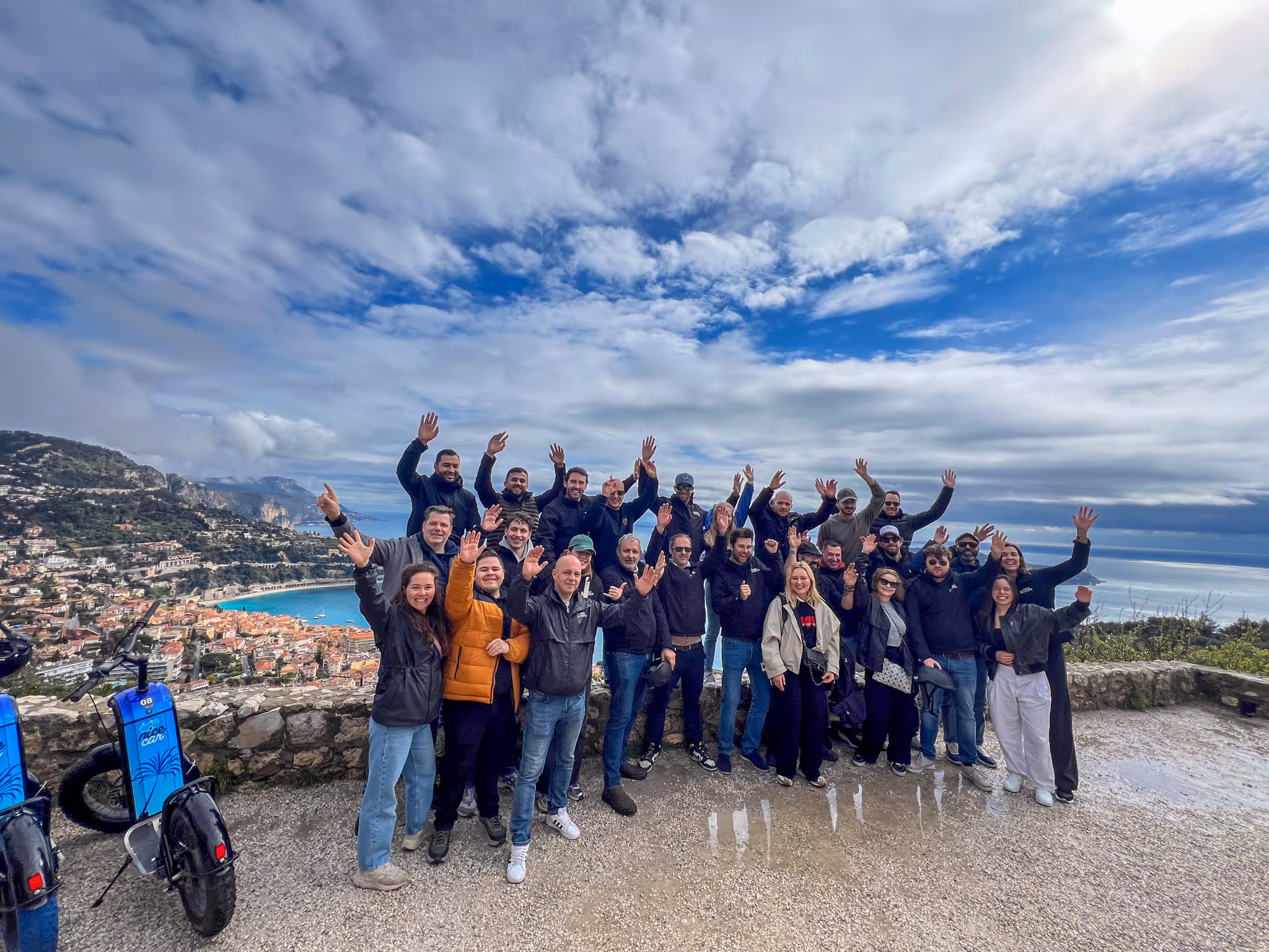 People smiling and waving for the photo