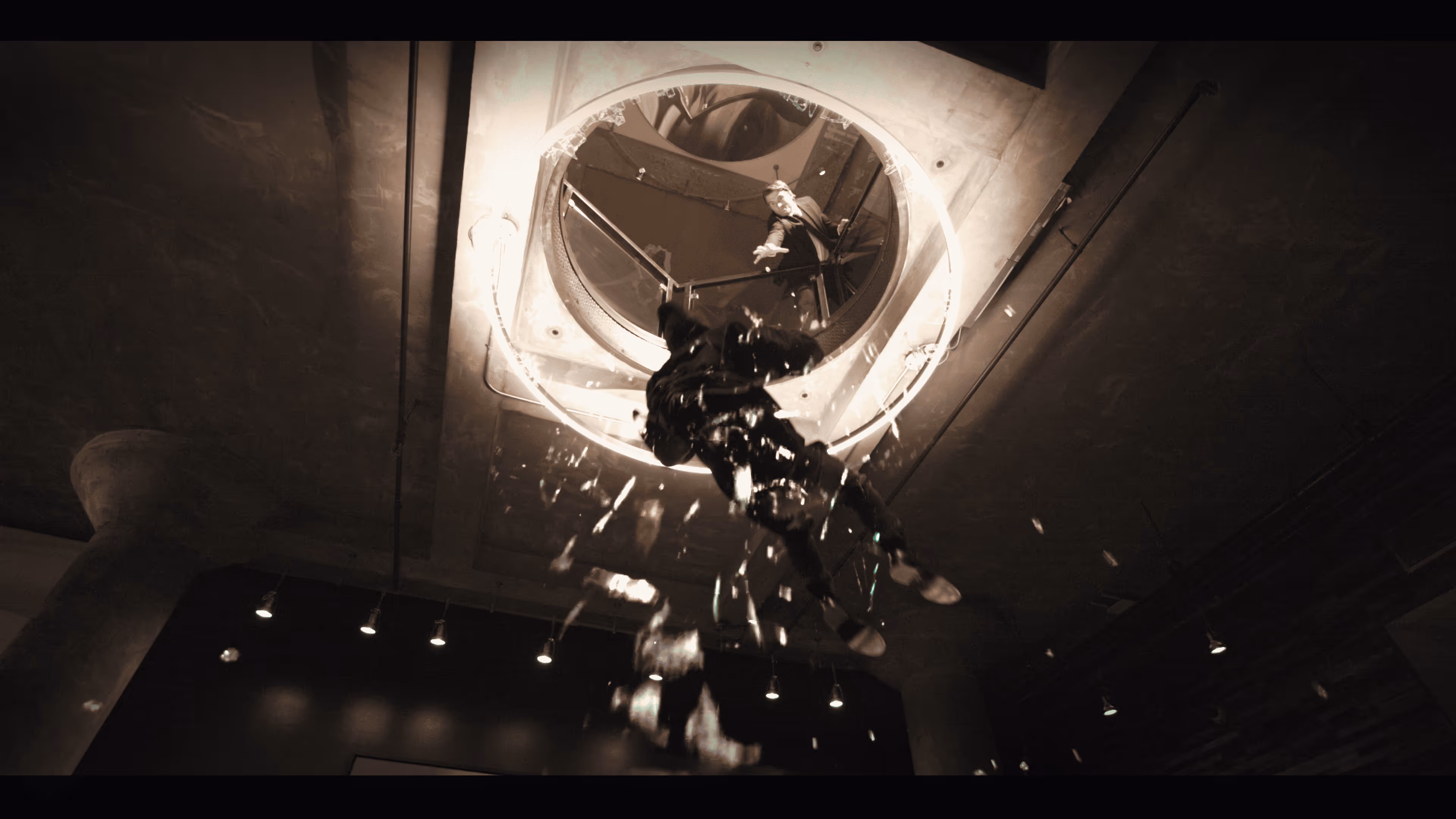 Person falling through a circular hole in the ceiling with glass shards breaking around them and another person reaching out from above.