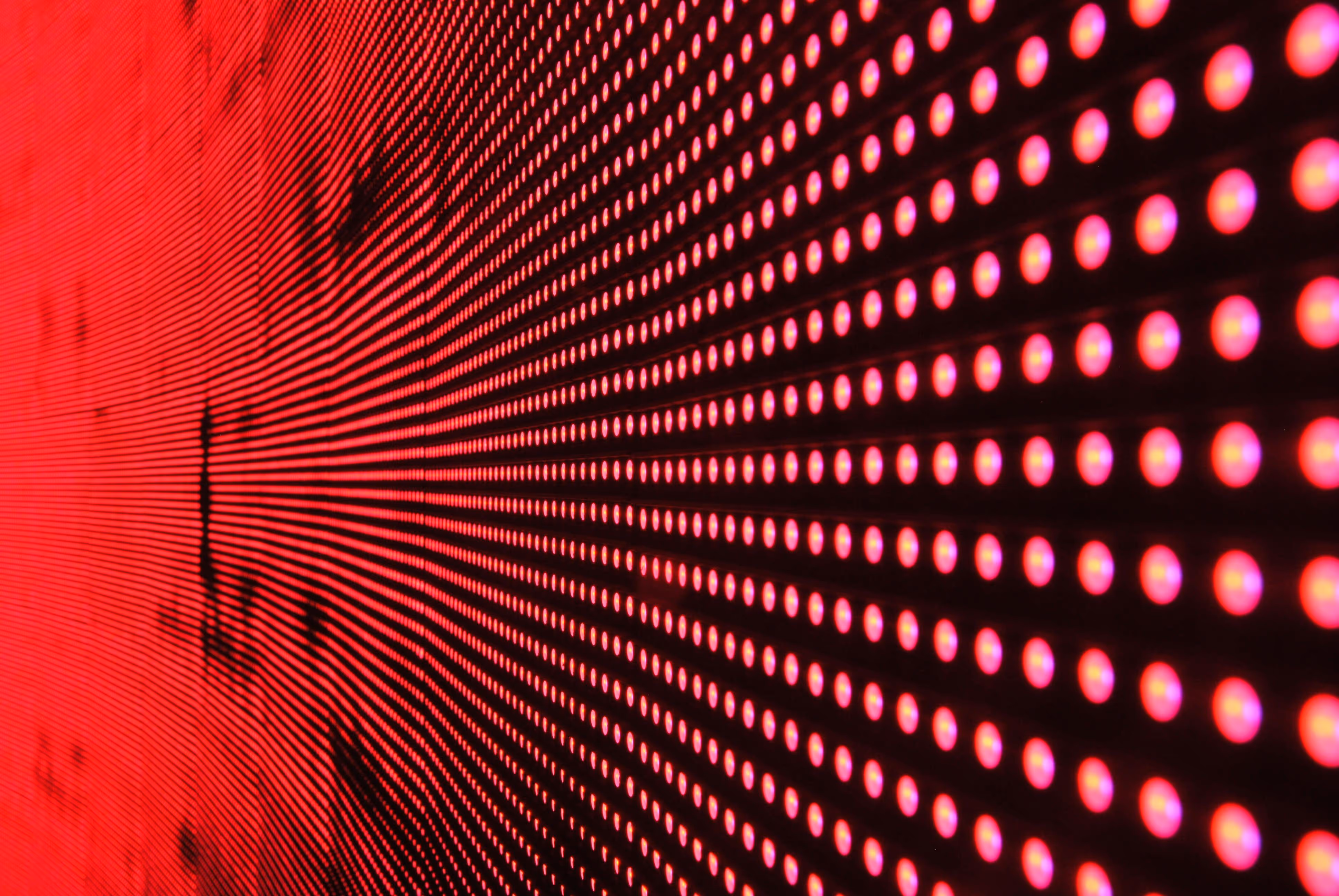 Close-up of a glowing red LED grid forming a tunnel-like perspective.