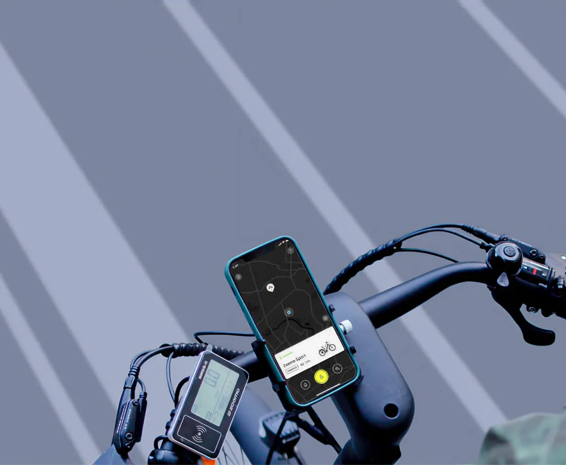 A close-up of a phone on a bike's handlebars, with the heading "My Zoomo App.